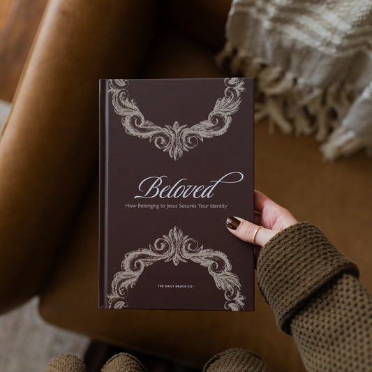 Book titled 'Beloved' held by a person with decorative cover design.