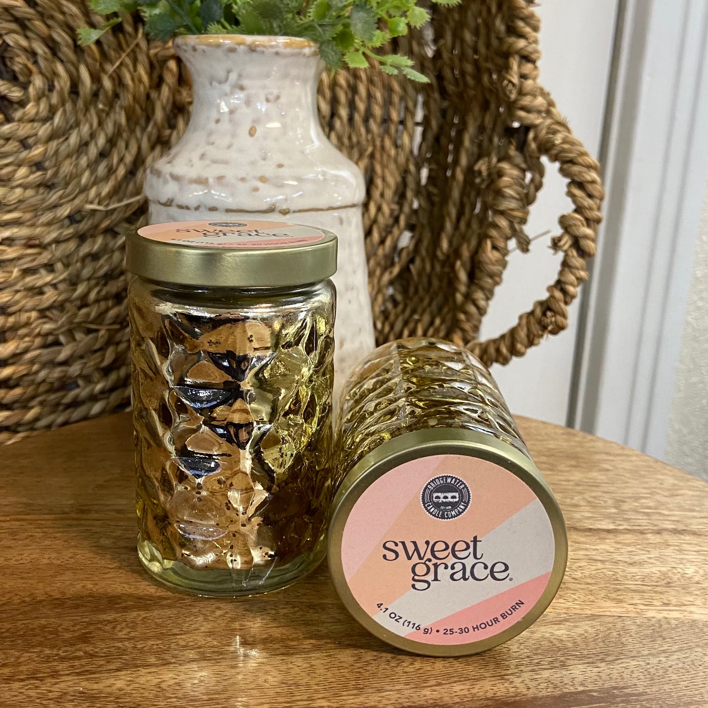 Two jars with decorative labels on a wooden surface, one labeled 'sweet grace'.