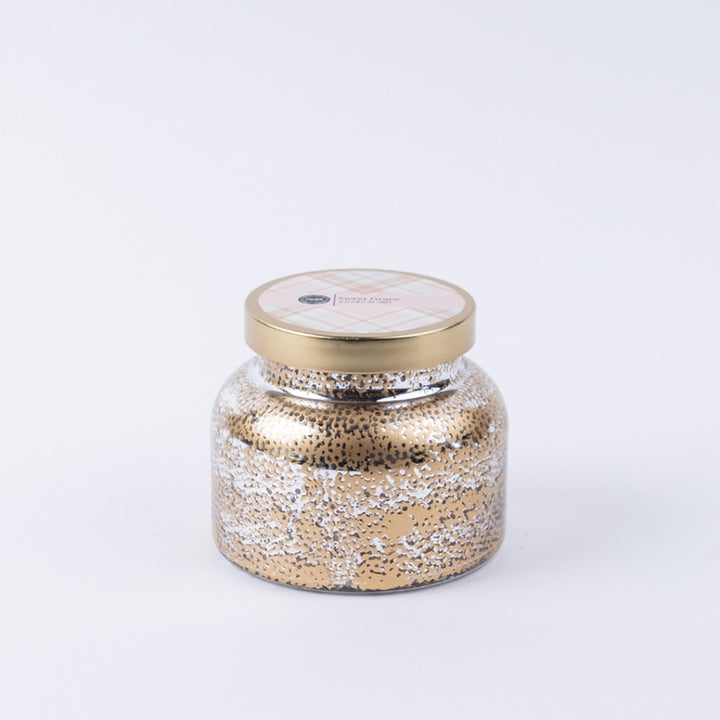 Decorative jar with a gold lid on a white background